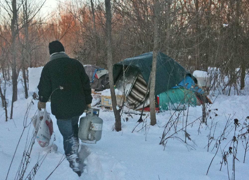 Joppa volunteer brings propane to homeless person's tent 
