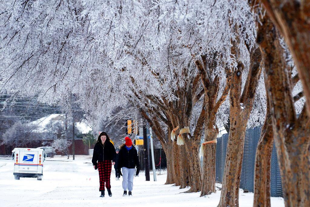 people walking down snowy street