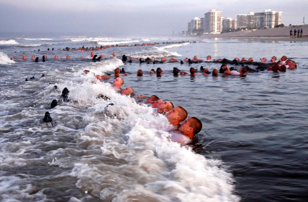 U.S. Navy SEAL candidates, participate in "surf immersion" during Basic Underwater Demolition/SEAL (BUD/S) training at the Naval Special Warfare (NSW) Center in Coronado, Calif., on May 4, 2020