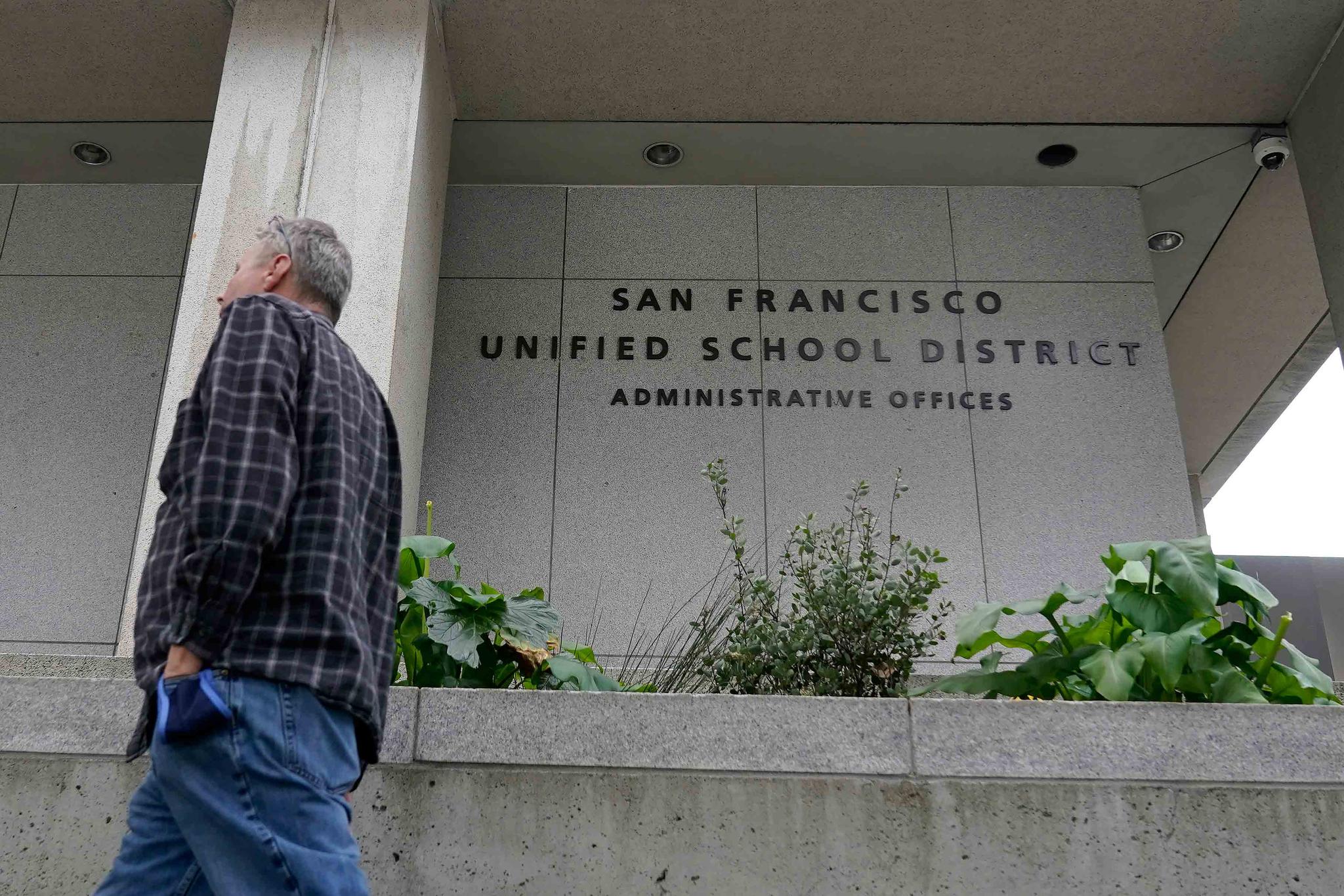 A pedestrian walks past a San Francisco Unified School District office building in San Francisco, Thursday, Feb. 3, 2022. 