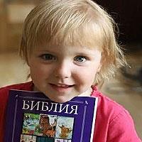 young girl with Russian Ukraine bible