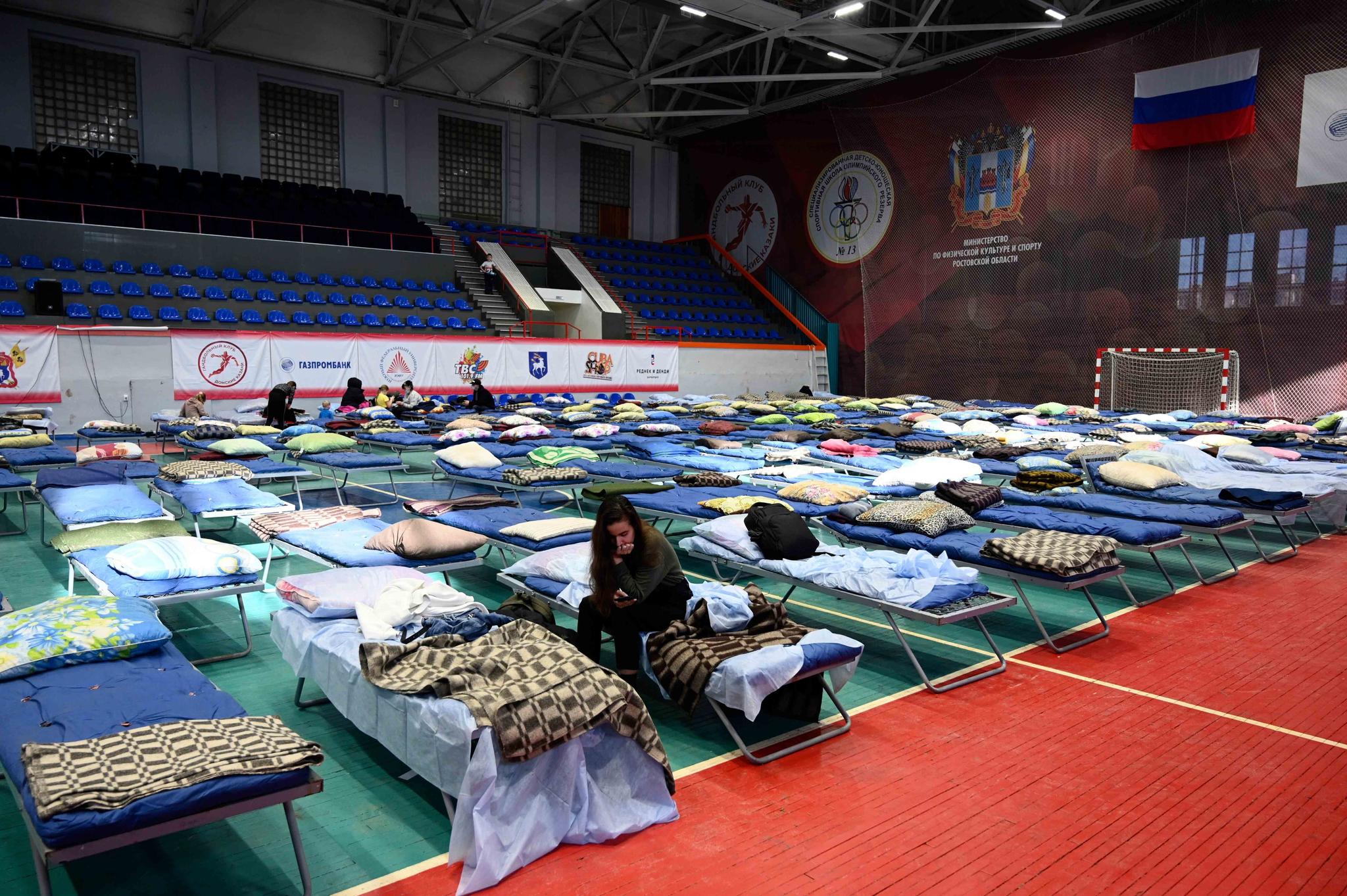 Displaced civilians from the Donetsk and Luhansk regions, the territory controlled by pro-Russia separatist governments in eastern Ukraine, rest in a sport hall in Taganrog, Russia, Monday, Feb. 21, 2022. 