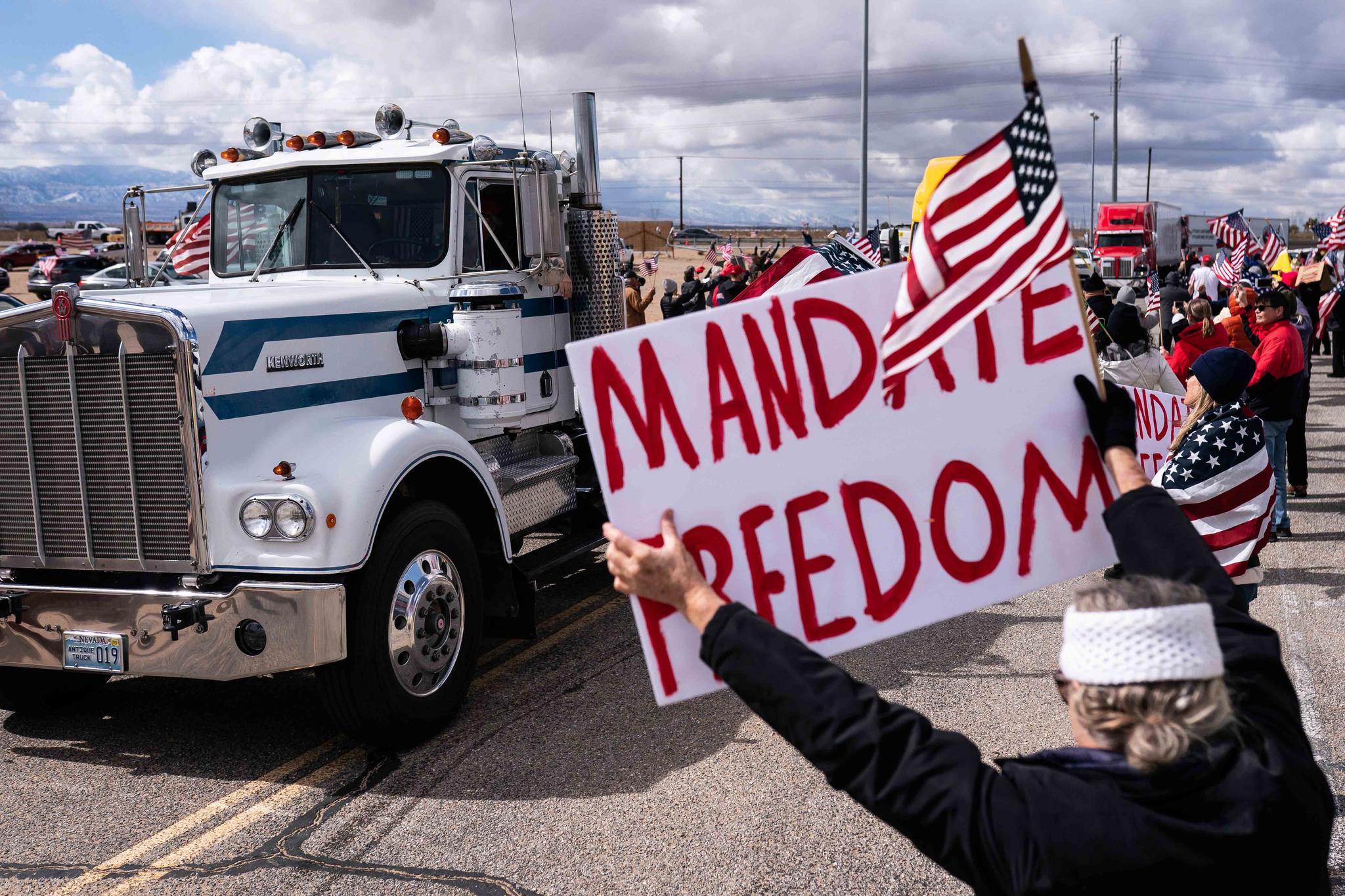 Supporters cheer on the beginning of a trucker caravan to Washington, D.C., called The People's Convoy on Wednesday, Feb. 23, 2022, in Adelanto, Calif. 