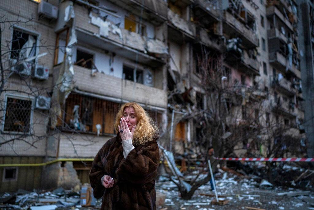 Matali Sevriukova reacts next to her house following a rocket attack in Kyiv, Ukraine 