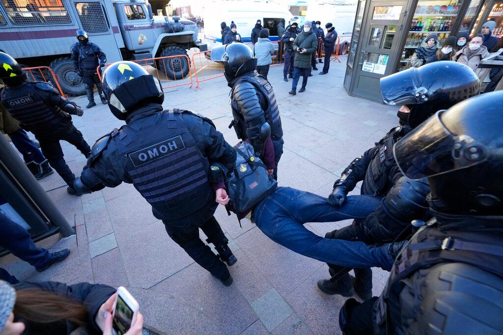 Police detain a demonstrator during an action against Russia's attack on Ukraine in St. Petersburg, Russia