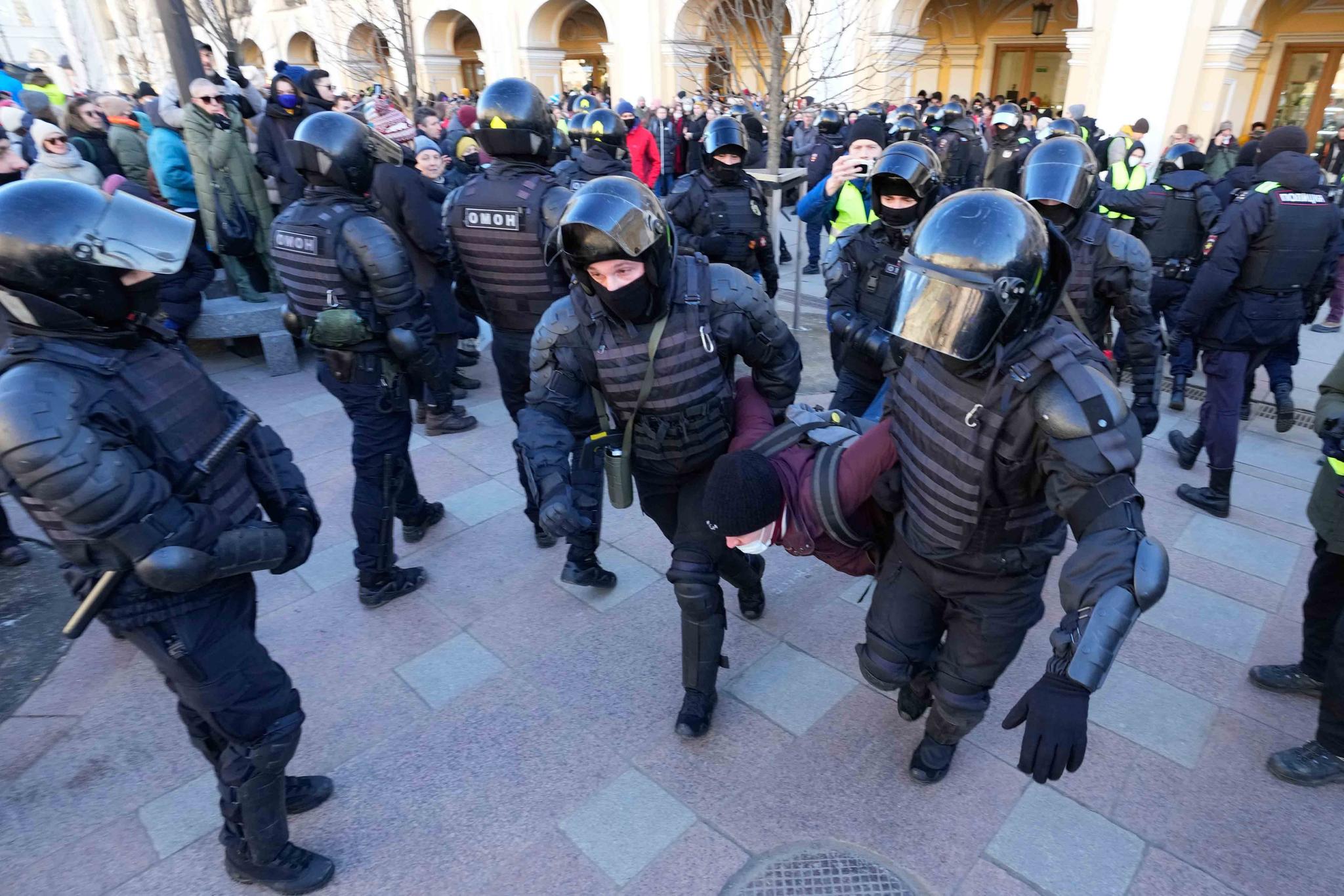 Police detain a demonstrator during an action against Russia's attack on Ukraine in St. Petersburg, Russia, Sunday, Feb. 27, 2022.