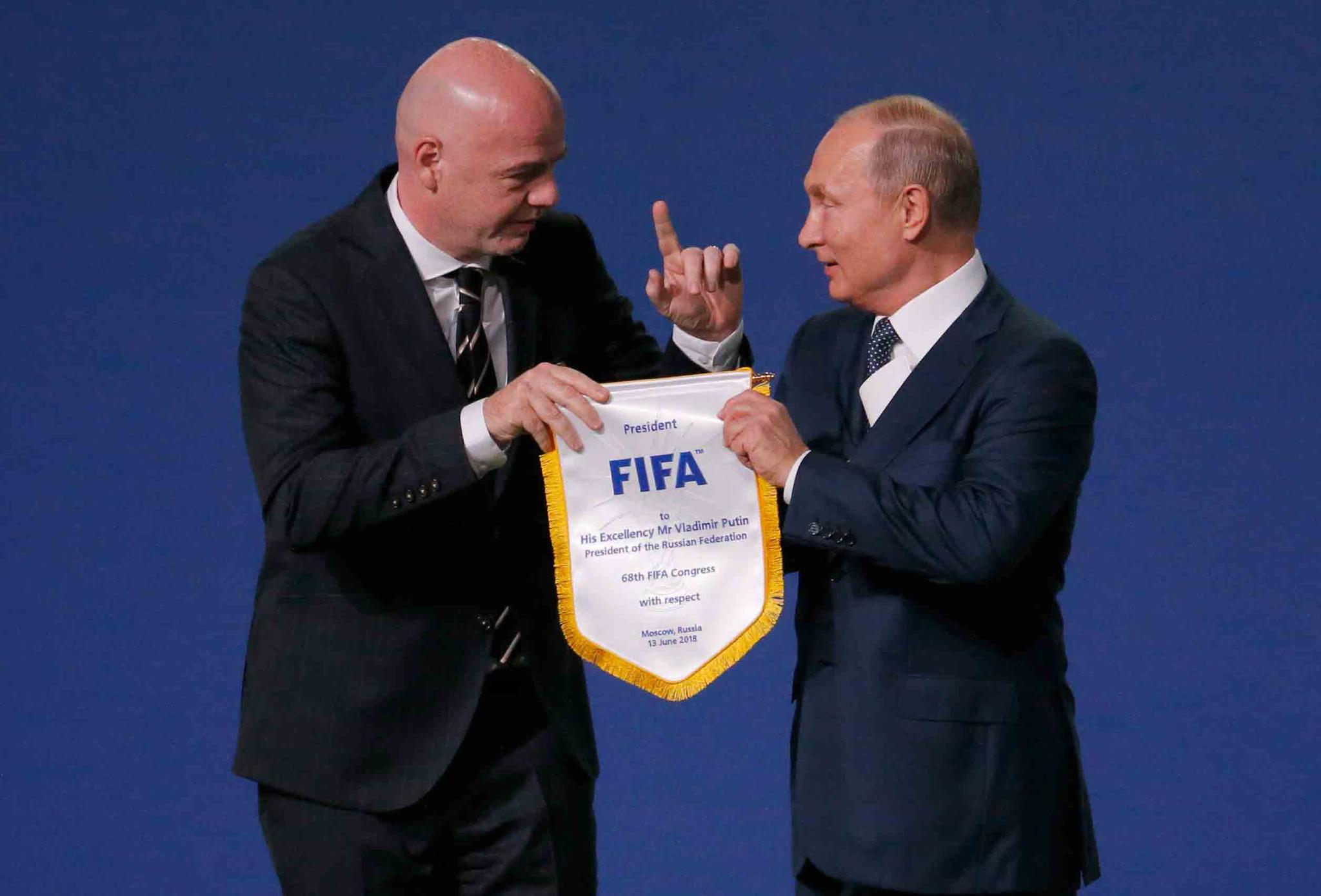 FIFA President Gianni Infantino, left, and Russian President Vladimir Putin pose for cameras at the FIFA congress on the eve of the opener of the 2018 soccer World Cup in Moscow, Russia, Wednesday, June 13, 2018.