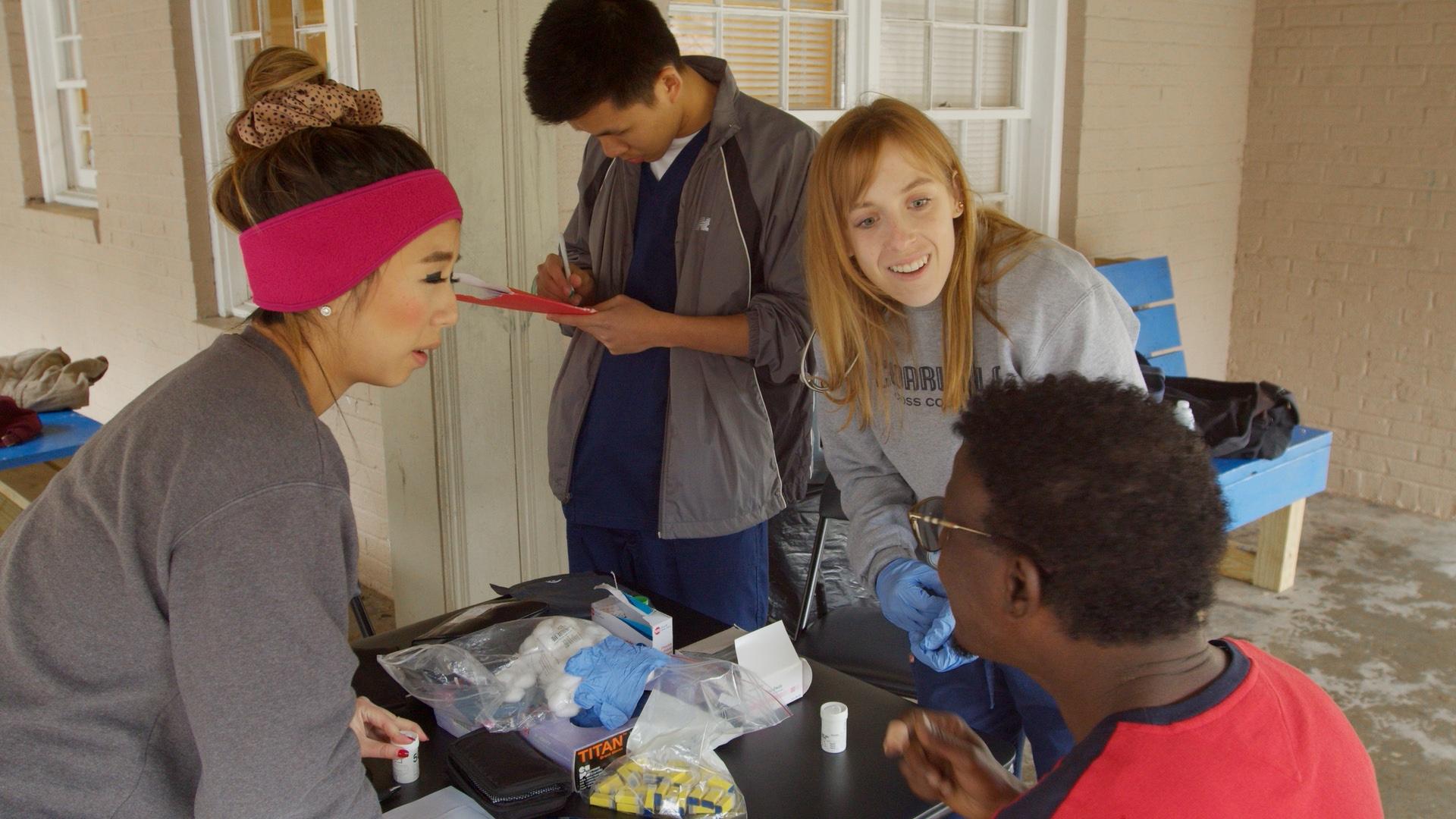 Nguyen taking down the patient’s information at the clinic in Clarkston, Georgia