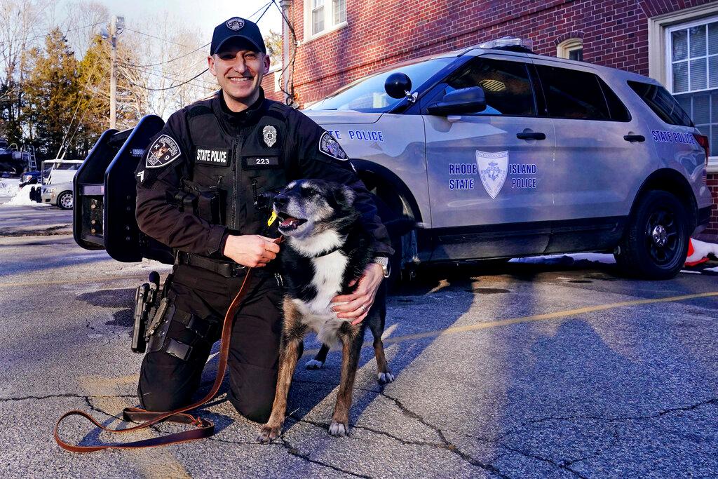 Rhode Island State Police Cpl. Daniel O'Neill poses with his partner, Ruby 