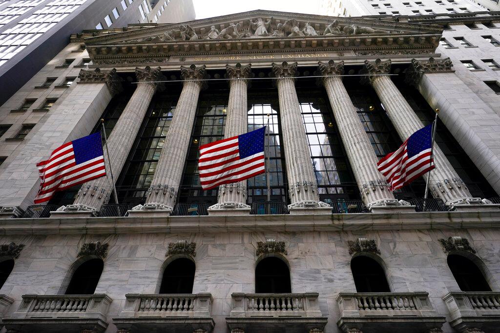 American flags fly outside the New York Stock exchange, Friday, Jan. 14, 2022, in the Financial District in New York. Stocks are opening lower on Wall Street, Thursday, March 23, giving back some of the big gains they made a day earlier.