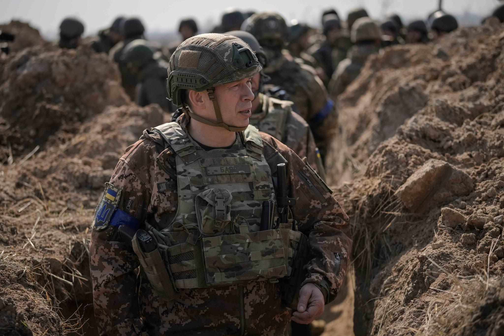 Col. Gen. Oleksandr Syrskyi, top military commander in charge of the defense of the Ukrainian capital, walks in a trench at a position north of the capital Kyiv, Ukraine, Tuesday, March 29, 2022.