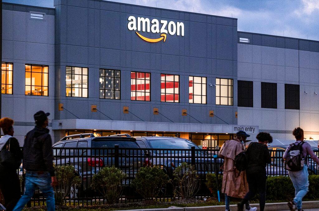 People arrive for work at the Amazon distribution center in the Staten Island borough of New York 