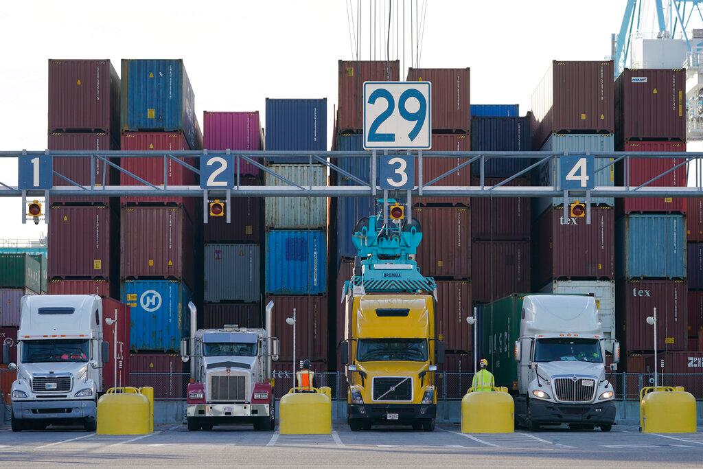 Trucks line up to have containers loaded from a stack at the Norfolk International Terminal