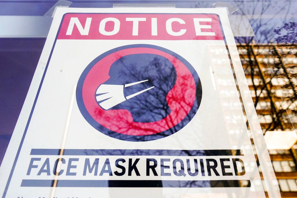 A sign requiring masks as a precaution against the spread of the coronavirus on a store front in Philadelphia