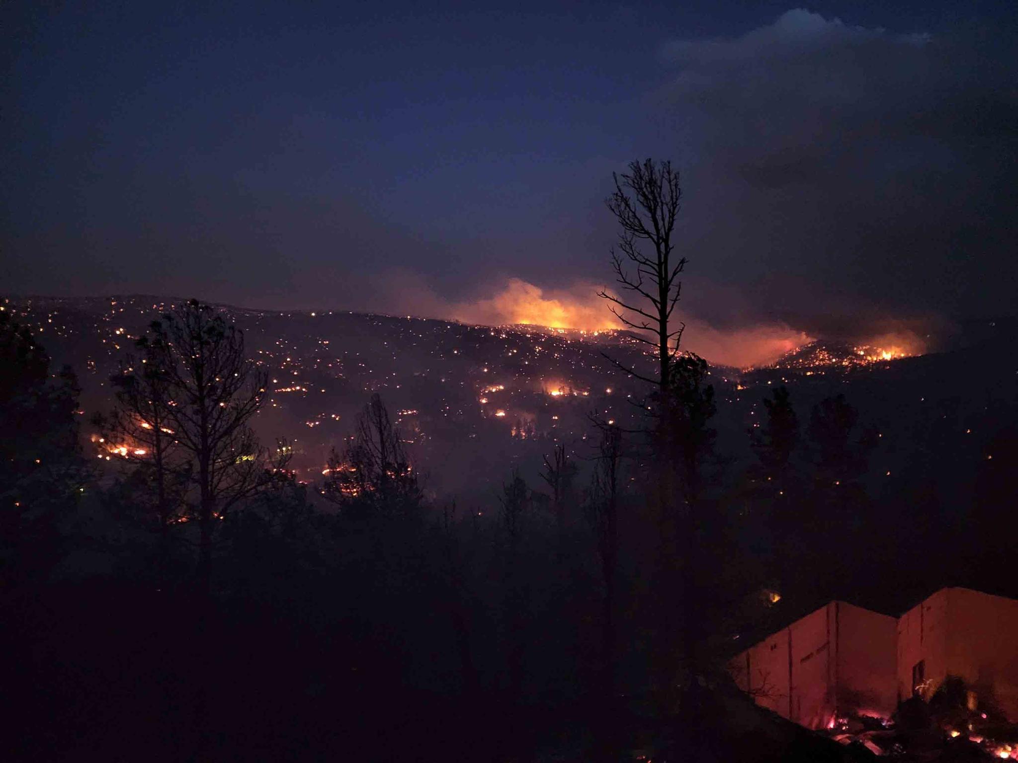 Fire burns along a hillside in the Village of Ruidoso, N.M., on Wednesday, April 13, 2022. Officials say a wildfire has burned about 150 structures, including homes, in the New Mexico town of Ruidoso.