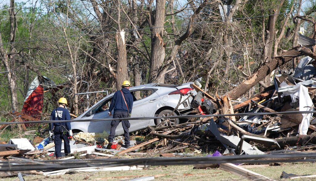 Wichita firefighters search a neighborhood in Andover, Kansas after a tornado struck on May 29, 2022