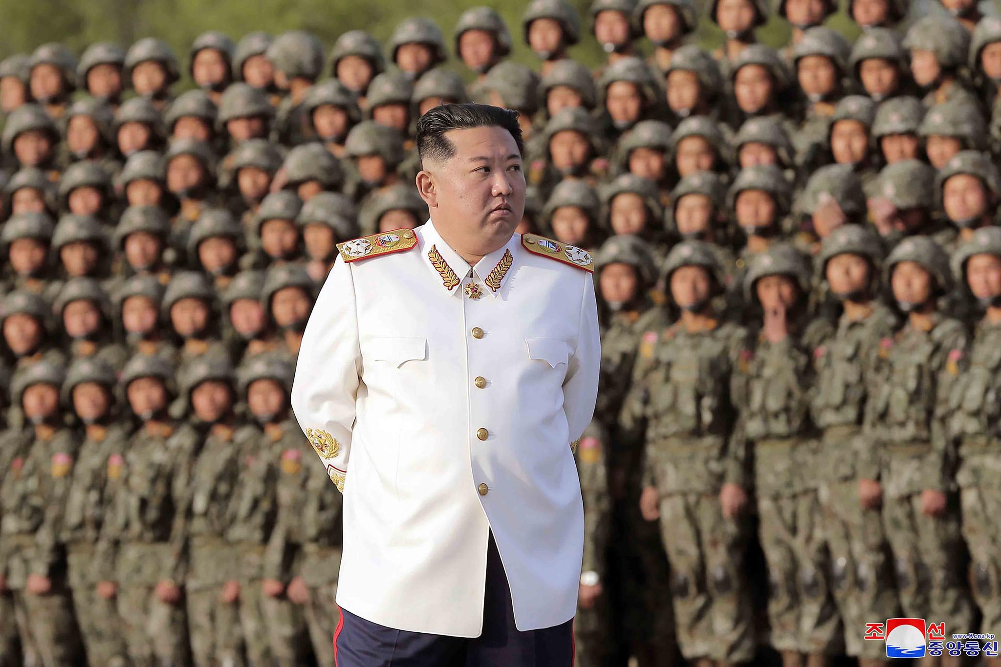 In this photo provided by the North Korean government, North Korean leader Kim Jong Un attends a photo session with the officers and soldiers who took part in a celebration the 90th founding anniversary of the Korean People's Revolutionary Army, in North Korea Wednesday, April 27, 2022.