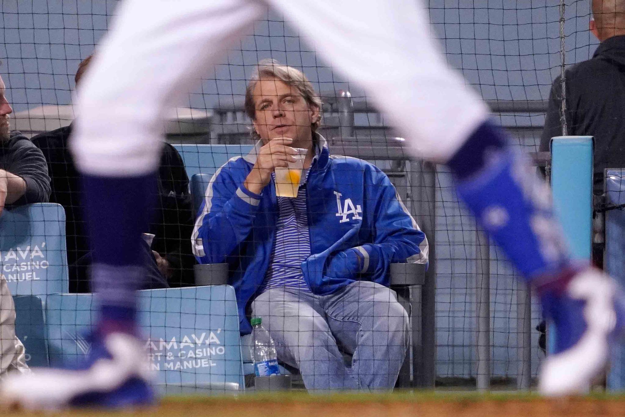 Los Angeles Dodgers co-owner Todd Boehly watches a baseball game against the Detroit Tigers Saturday, April 30, 2022, in Los Angeles. Chelsea is being sold to a consortium fronted by American sports investor Todd Boehly.
