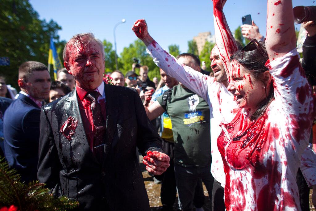 Pro-Ukrainian activists shout slogans as Sergey Andreev Russian Ambassador to Poland is covered with red paint in Warsaw, Poland 