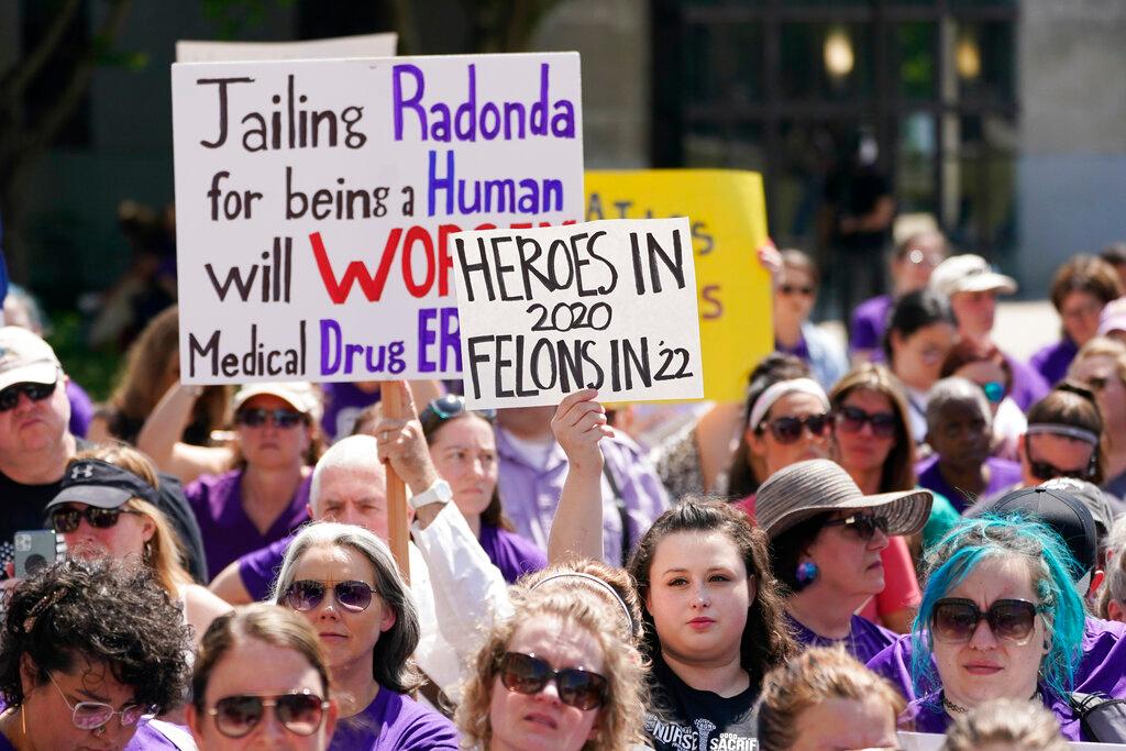 People demonstrate outside the courthouse where the sentencing hearing for former nurse RaDonda Vaught is being held
