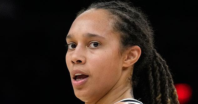 Woman with braids and basketball jersey