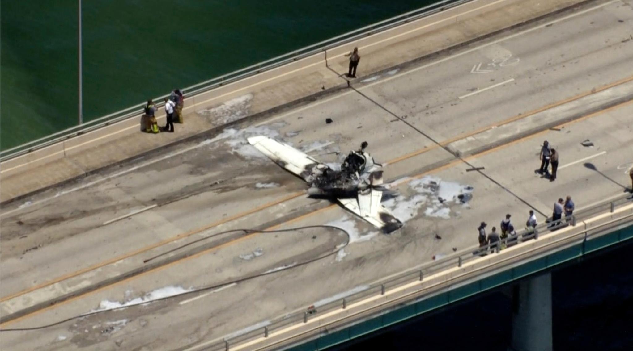 This photo provided by WSVN-TV emergency personnel respond to a small plane crash in Miami on Saturday, May 14, 2022.