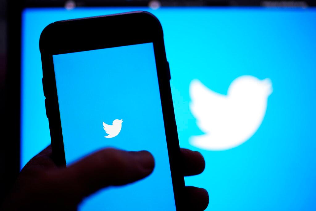 The Twitter application is seen on a digital device