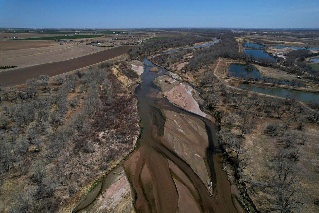 The South Platte River flows on Thursday, April 28, 2022, in Fort Morgan, Colo. As climate change-fueled megadrought edges eastward, Nebraska wants to divert water in Colorado by invoking an obscure, 99-year-old compact between the states that allows Nebraska to seize Colorado land along the South Platte River to build a canal.