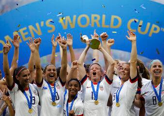 woman's soccer team cheering with arm up