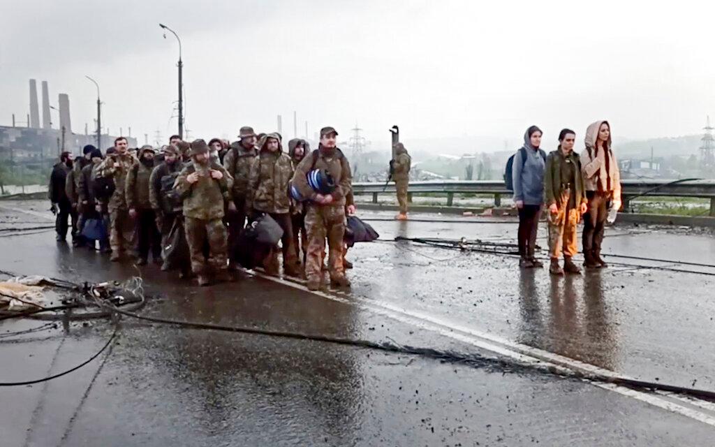 Ukrainian servicemen leave the besieged Azovstal steel plant in Mariupol, in territory under the government of the Donetsk People's Republic, eastern Ukraine.