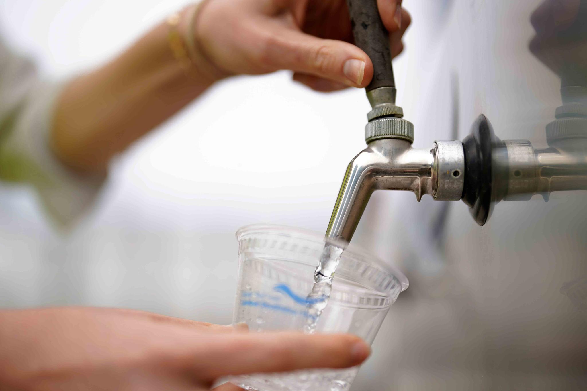An official at the Carlsbad Desalination plant fills a cup with filtered water made from ocean water, Thursday, May 26, 2022, in Carlsbad, Calif.