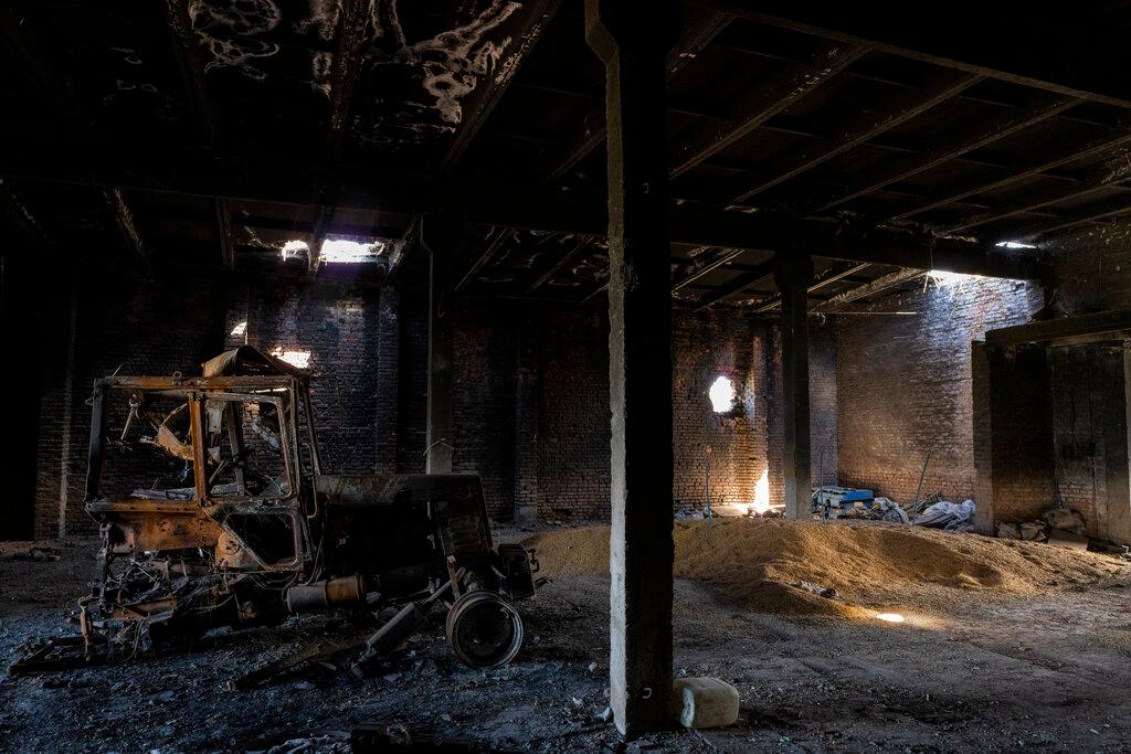 Tractor charred by a Russian attack lies inside a warehouse at a grain farm in Cherkaska Lozova, outskirts of Kharkiv, eastern Ukraine