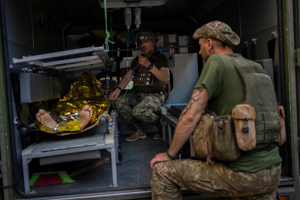 An injured Ukrainian servicemen is transferred to a medical facility after getting an emergency medical treatment in the Donetsk region, eastern Ukraine