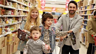 mom and dad pushing kids in shopping cart