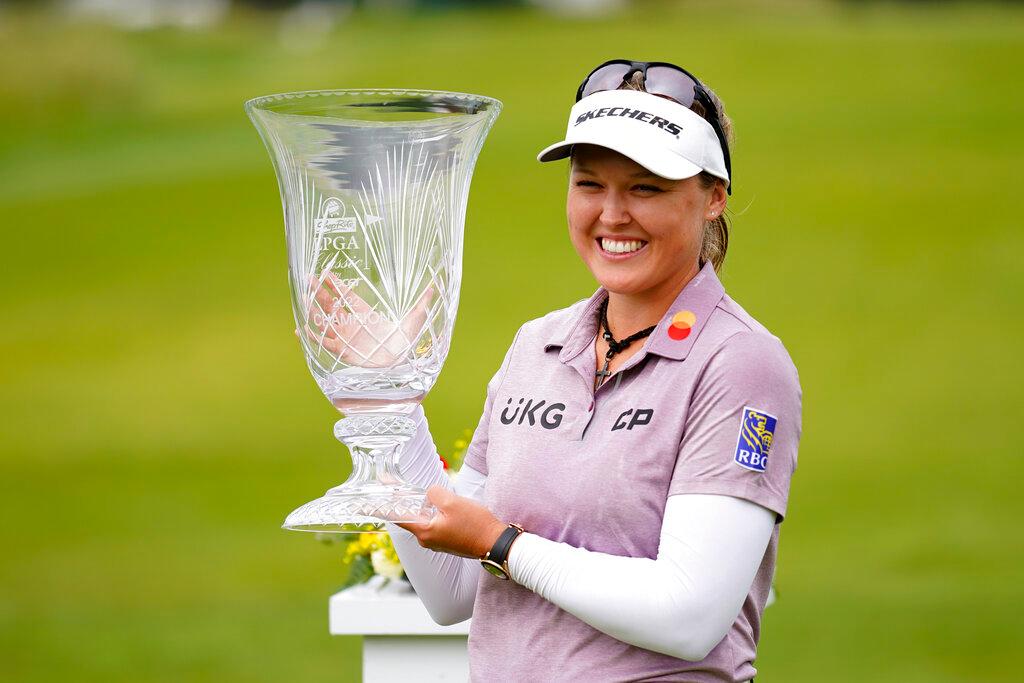 winner holding trophy