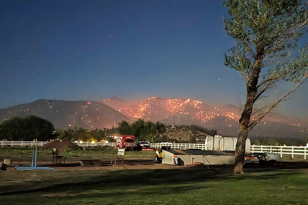 Flames twinkling on a mountain on the outskirts of Flagstaff, Arizona.
