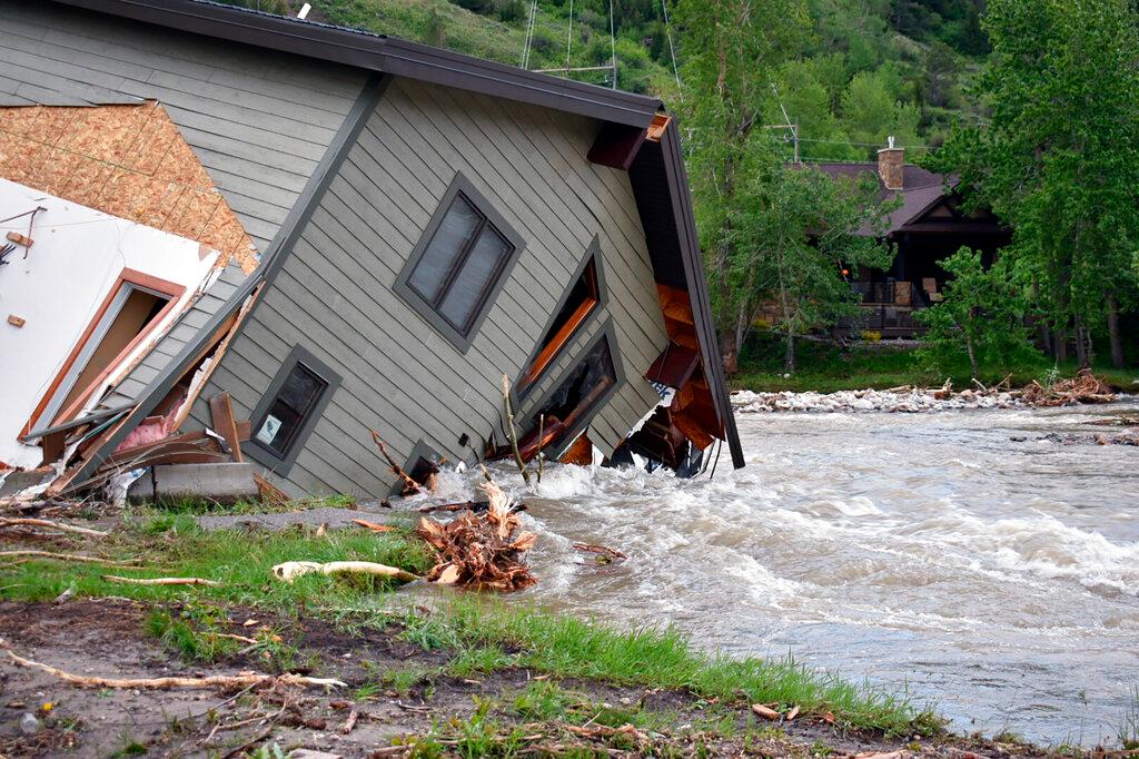 A house that was pulled into Rock Creek in Red Lodge, Mont., by raging floodwaters 