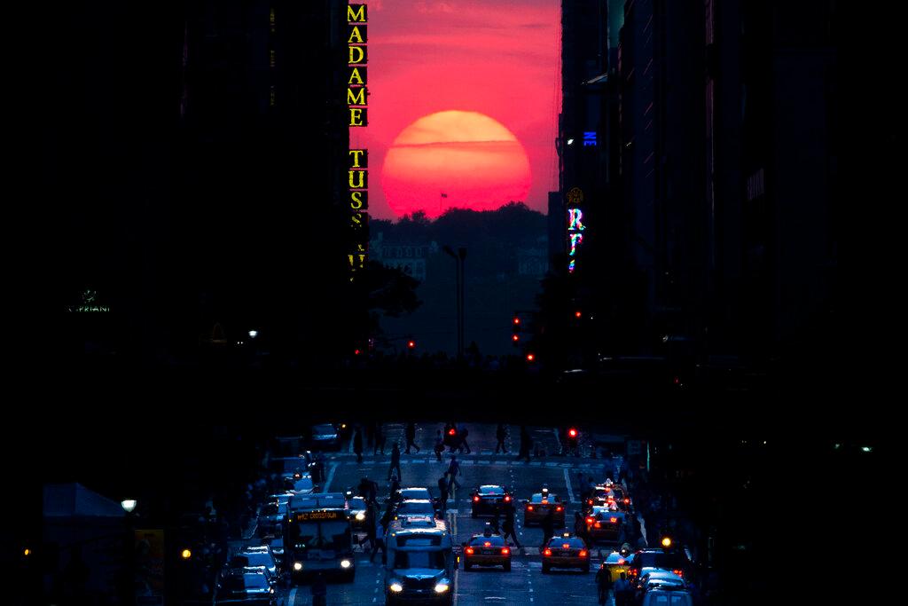 The sun sets along 42nd Street in Manhattan during an annual phenomenon known as "Manhattanhenge," when the sun aligns perfectly with the city's transit grid
