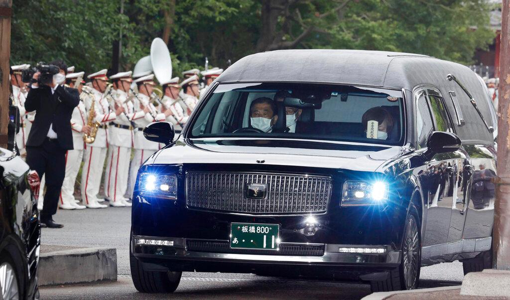 Akie Abe, wife of former Prime Minister Shinzo Abe, sitting at right, is seen in the hearse carrying Abe's body as it leaves Zojoji temple after his funeral in Tokyo