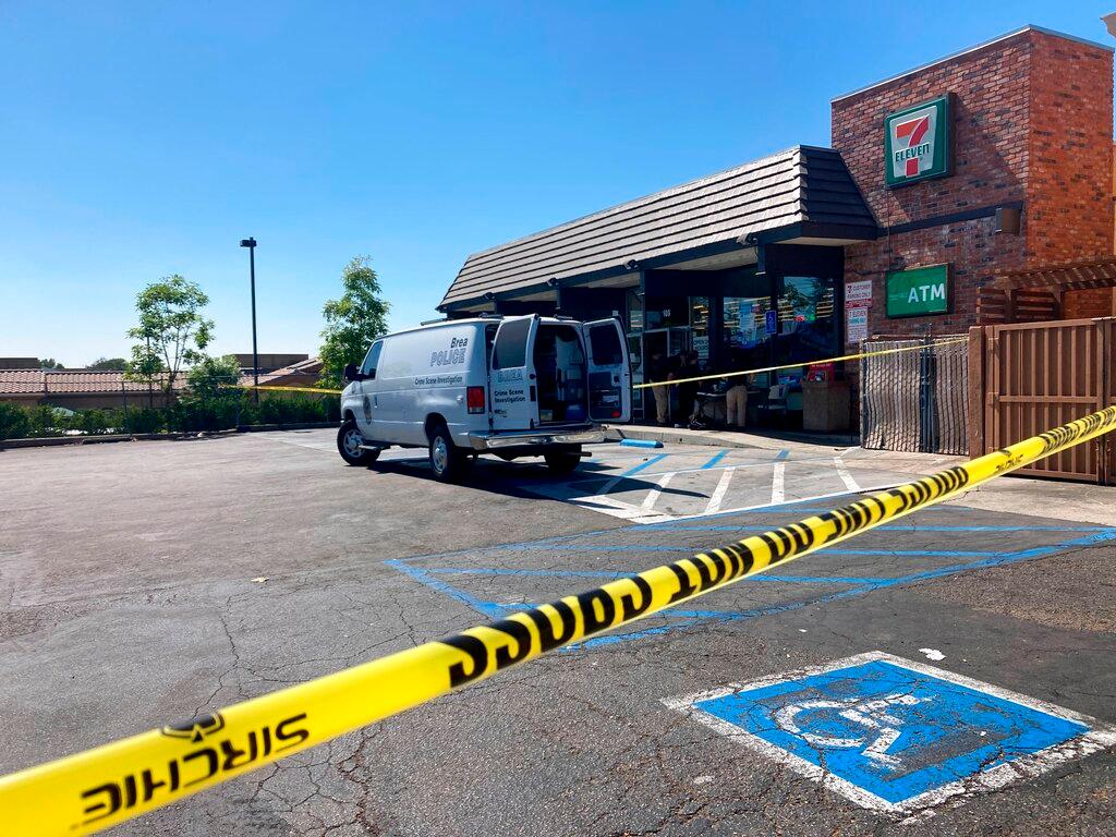 Police investigate a shooting at a 7-Eleven store in Brea, Calif.