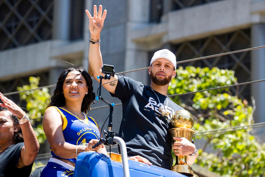 Golden State Warriors' Stephen Curry accompanied by his wife Ayesha