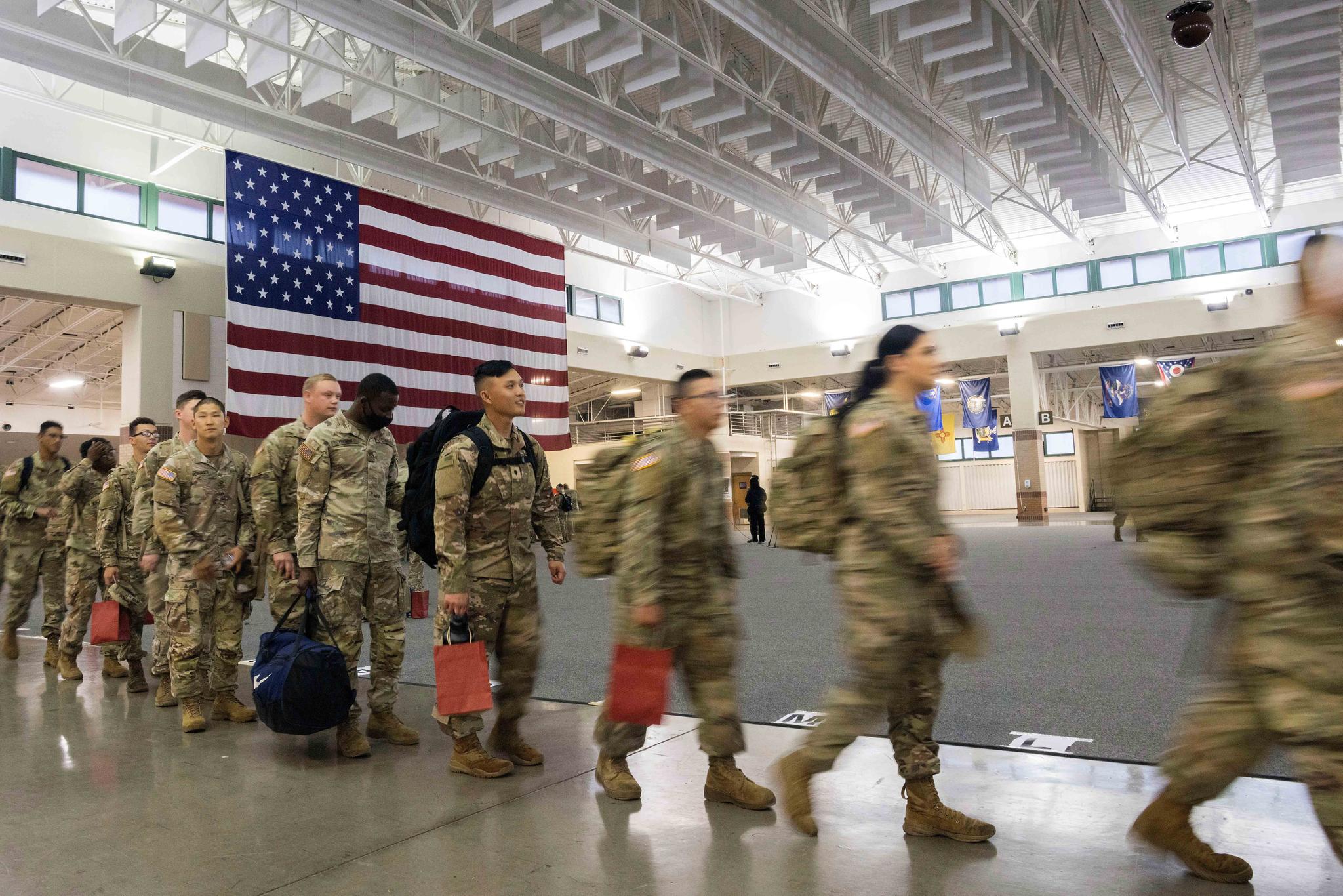 About 130 soldiers with the U.S. Army's 87th Division Sustainment Support Battalion, 3rd Division Sustainment Brigade, wait to board a chartered plane during their deployment to Europe, March 11, 2022, at Hunter Army Airfield in Savannah, Ga.