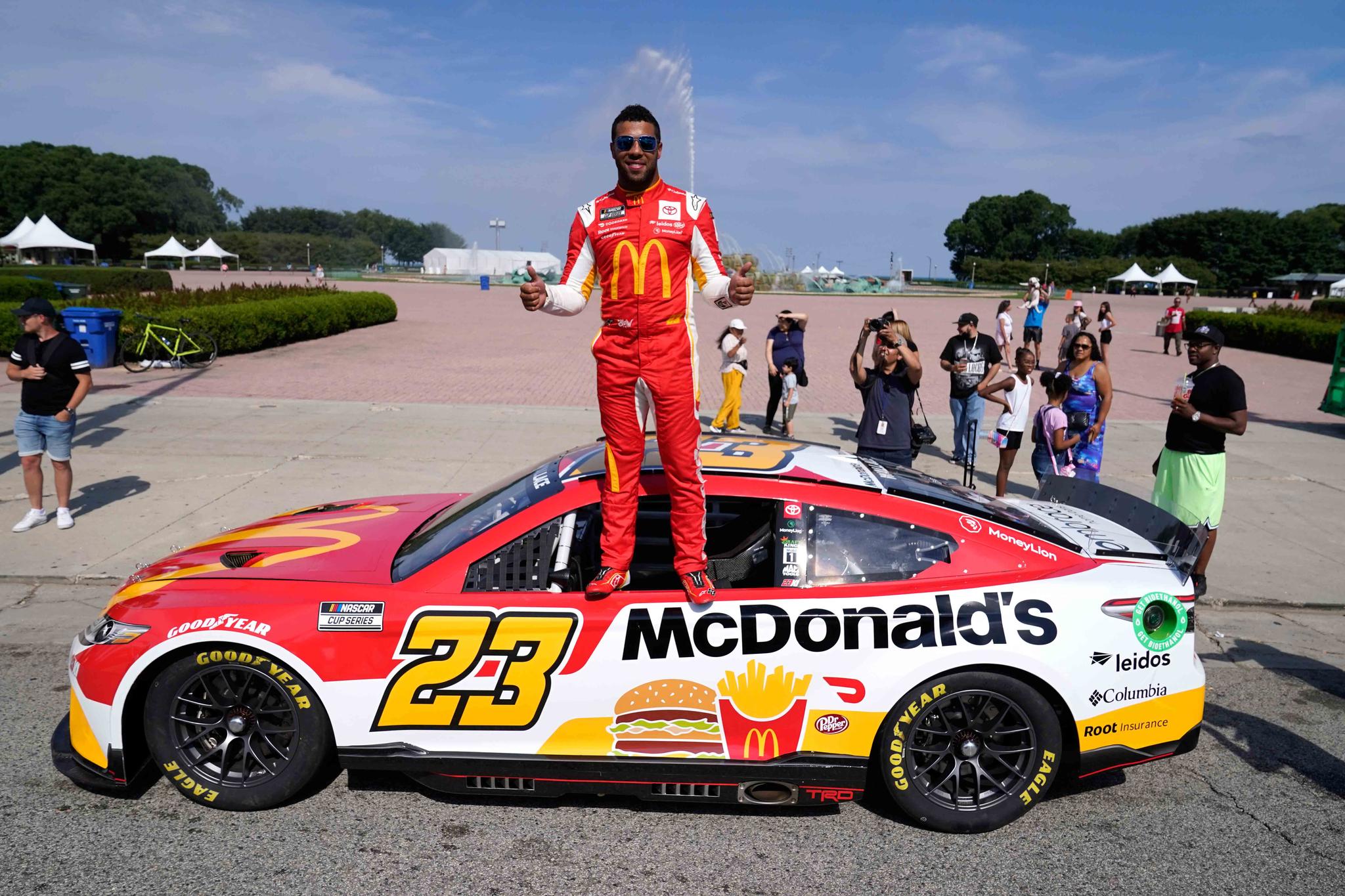 NASCAR driver Bubba Wallace poses for photographers near Buckingham Fountain on Tuesday, July 19, 2022, in Chicago during a promotional visit to announce a NASCAR Cup Series street race in the city, to be held July 2, 2023.