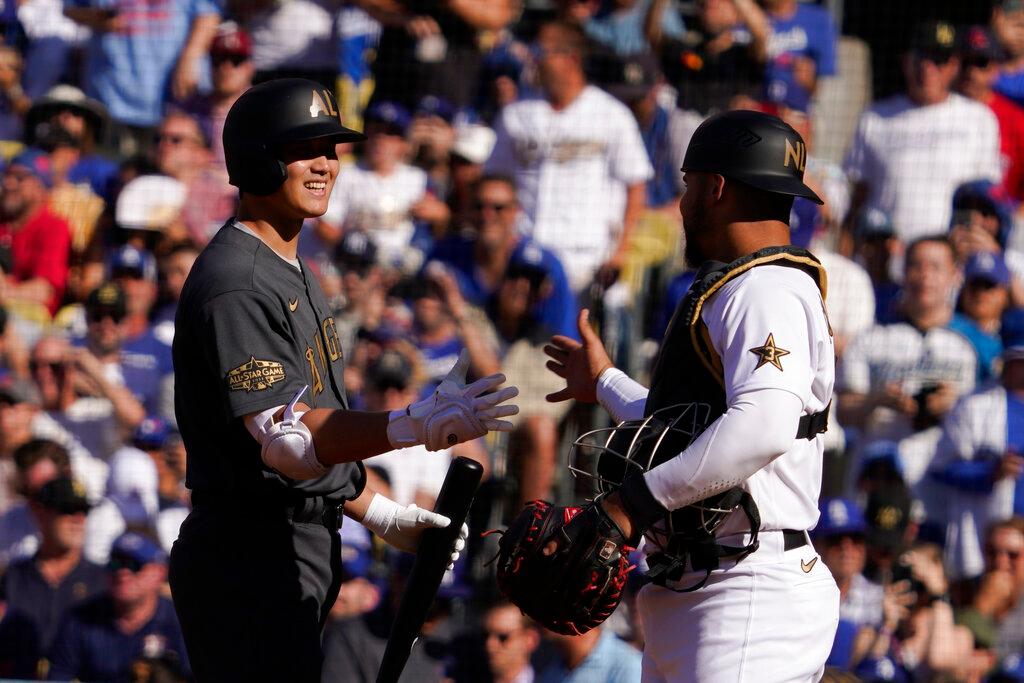 American League designated hitterShohei Ohtani, left, of the Los Angeles Angels, is greeted by National League's catcher Wilson Contreras, of the Chicago Cubs