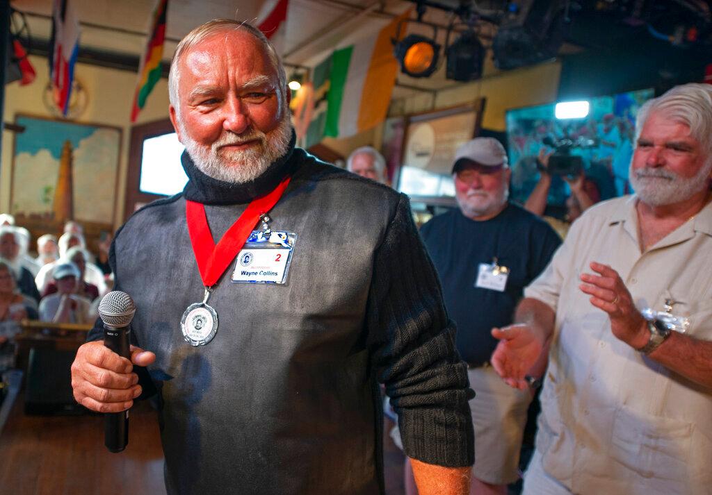 Wayne Collins, left, tries to impress the judges during the first round of the "Papa" Hemingway Look-Alike Contest