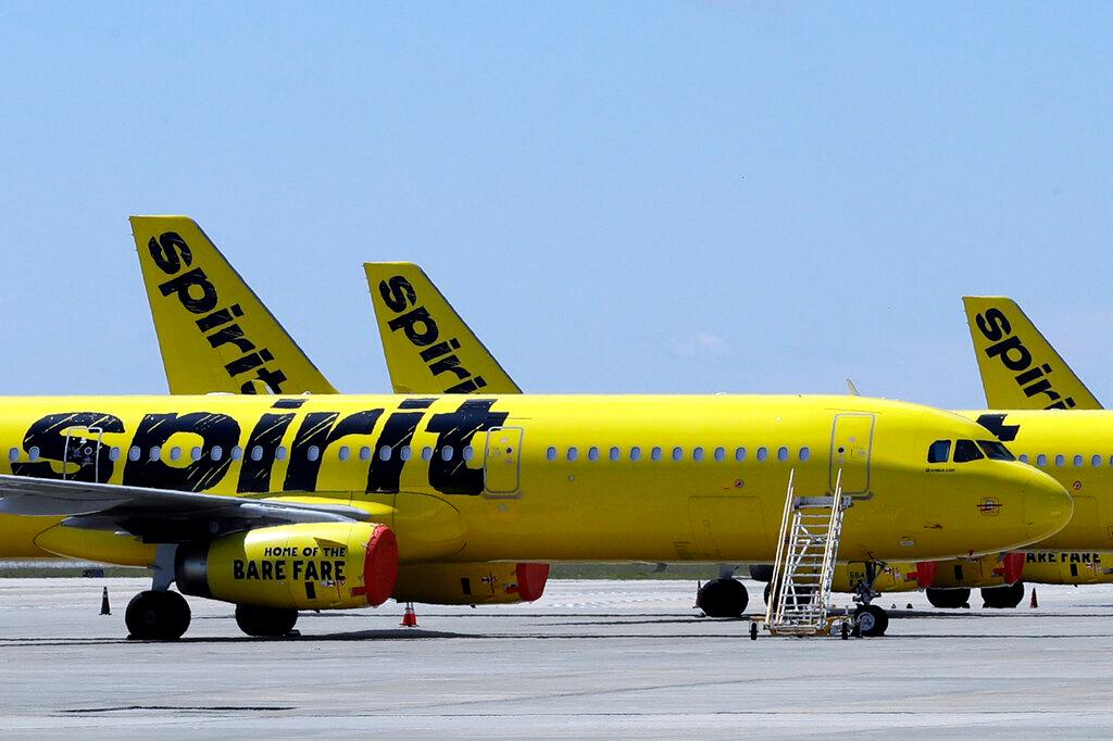 A line of Spirit Airlines jets sit on the tarmac at Orlando International Airport on May 20, 2020, in Orlando, Fla. Spirit Airlines shareholders could pick a preferred buyer for their airline Wednesday, July 27, 2022, when they are scheduled to vote on one of the offers for the budget carrier. Shareholders appear to be leaning against the bid preferred by Spirit’s board, a merger offer from Frontier Airlines that is currently worth more than $2.6 billion.