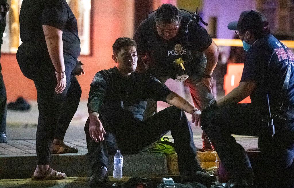 Police officer Ramon Perez is treated for shock after an SUV drove through the parade route of the Intertribal Ceremonial Centennial Celebration in Gallup, New Mexico