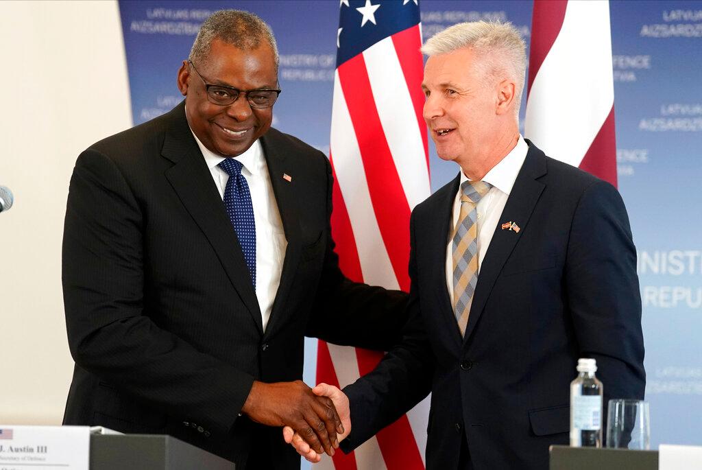 U.S. Secretary of Defense Lloyd Austin, left, and Latvian Minister of Defence Artis Pabriks