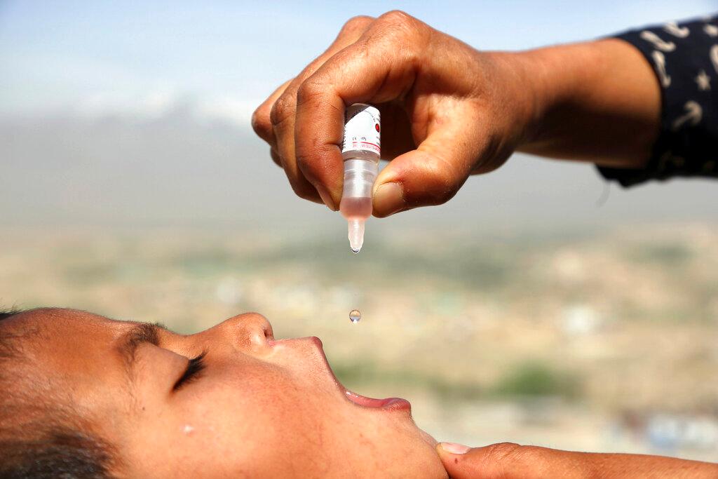 Health worker uses an oral polio vaccine on a child as part of a campaign to eliminate polio, on the outskirts of Kabul, Afghanistan