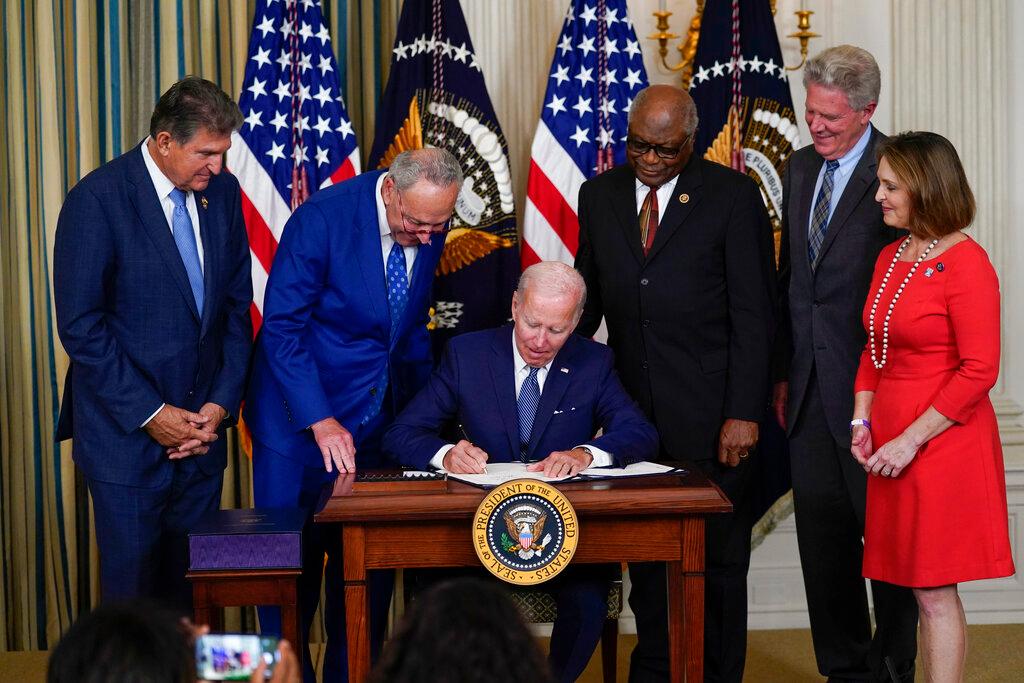Lawmakers watch as bill is signed.